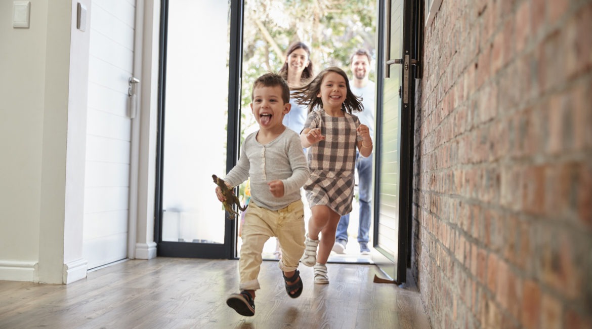 Excited Children Arriving Home With Parents